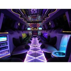 the inside of a limo with purple lights and black leather seats on both sides is lit up