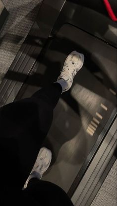 a person standing on top of a metal object with their feet in the air,