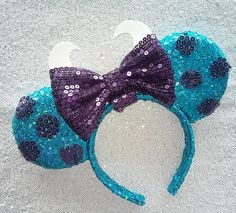 a blue and purple minnie mouse ears with sequins