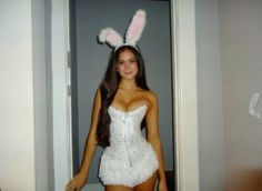 a woman in bunny ears is posing for the camera