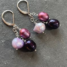 Purples Pearl Trio- These are fun pearls in eggplant, lavender and mauve wired in sterling silver with sterling leverbacks, which are necessary for this design. The APPRX length is 1 7/8”. As all pearls are unique, each pair created will be unique but be made from the same lot of pearls as the ones shown. Your earrings will be beautifully gift boxed. Adjustable Purple Jewelry With Lever Back Ear Wires, Handmade Purple Dangle Pearl Earrings, Purple Pearl Drop Jewelry, Purple Pearl Drop Jewelry Gift, Purple Dangle Pearl Drop Earrings, Purple Pearl Drop Dangle Earrings, Purple Dangle Pearl Earrings As Gift, Purple Pearl Drop Earrings, Purple Pearl Drop Jewelry As A Gift