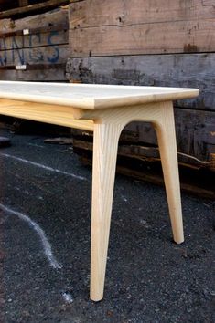 a wooden table sitting on top of a parking lot