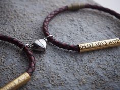 a couple of bracelets sitting on top of a rock