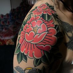 a woman's arm with a flower tattoo on it