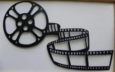 an image of a film reel cut out on the side of a white wall with a black frame