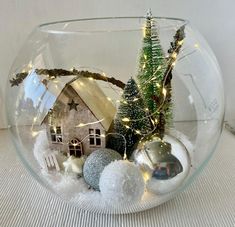 a glass bowl filled with ornaments and lights