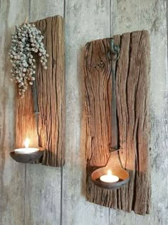 two wooden wall sconces with candles on them