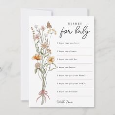 a card with the words wishes for baby written on it and some flowers in front