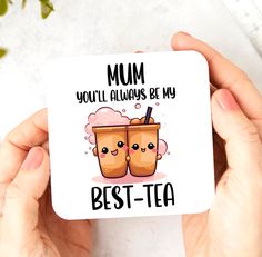 two hands holding up a coaster with the words mom you'll always be my best - tea on it