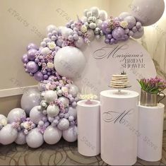 a table with balloons, cake and other items for a bridal party or wedding