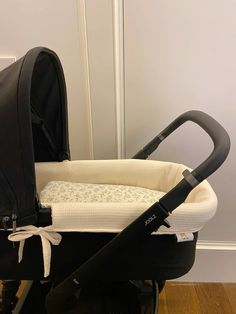 a stroller with a black and white cover on it