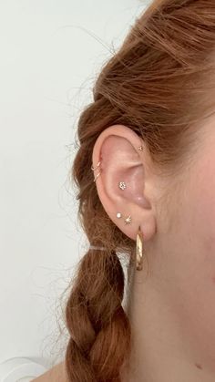 a close up of a person wearing a pair of ear piercings in their ears