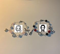 two bracelets that have pictures of people on them, one with a cross and the other with a woman's face