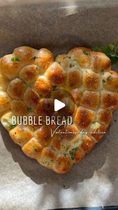 a heart shaped pastry sitting on top of a piece of paper with the words bubble bread