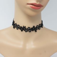 Make an impact everywhere you go when you show up wearing the Astrid Black and Silver Daisy Lace Choker. Each of the tiny flowers is decorated with silver-plated brass beads for a subtle yet eye-catching sparkle. This sexy daisy lace choker is lightweight, flexible, and comfortable to wear for casual or formal occasions or as an everyday statement necklace. Choose between a classic elegant metal clasp + chain or a flirty black silk ribbon to tie your choker in a cute bow. CHOKER SIZE + MATERIALS Black Flower Jewelry For Summer, Adjustable Flower Choker For Parties, Summer Party Flower Shaped Choker, Black Jewelry For Spring Party, Bow Choker, Lace Choker, Make An Impact, Gothic Accessories, Classic Elegant