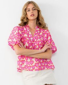 Get hearts racing with this playful Heart Puff Sleeve Blouse. Featuring a charming heart print and flirty puff sleeves, this top adds a touch of whimsy to any outfit. Perfect for those who don't take themselves too seriously, this blouse is sure to turn heads with its quirky style. #kardenlane #onlineboutique #thewoodlandsboutique #clothesforvalentinesday Valentines Collection, Cream Trousers, Heart Top, Heart Dress, Puff Sleeve Blouse, Puff Sleeve Top, The Chic, Heart Print, Flutter Sleeve