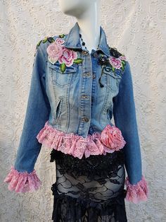 a mannequin wearing a jean jacket with pink roses on it and lace trims