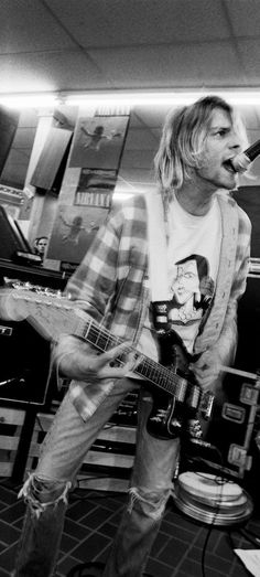 black and white photograph of man playing guitar