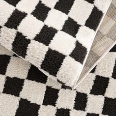 black and white checkered rugs on top of each other