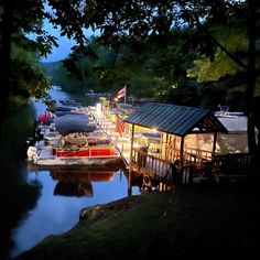 several boats are docked in the water at night