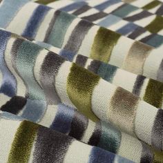 multicolored striped fabric with different colors and sizes on the bottom half of it