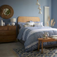 a bedroom with blue walls and furniture