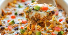 a spoon full of mexican chicken casserole being lifted from the casserole dish