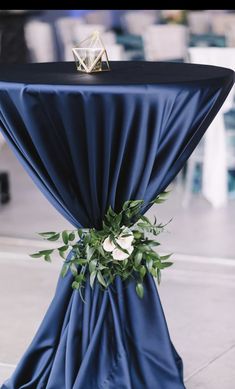 the table is covered with blue cloth and flowers