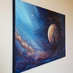 a painting on the wall of a room with blue and purple clouds, planets and stars