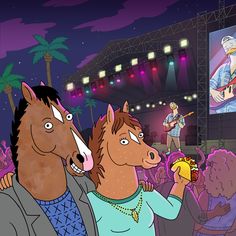 two horses are standing in front of a crowd at a concert, and one horse is eating something