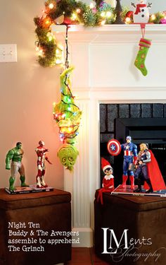 christmas decorations are displayed in front of the fireplace with stockings and toys hanging from it