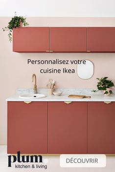 a bathroom with pink cabinets and white counter tops