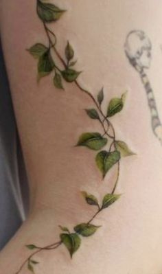 a close up of a person's leg with vines on it