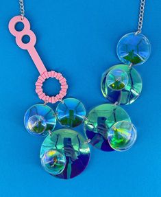 Double Bubble necklace is a fun and quirky piece to pair with a your outfit. The necklace is made from our fabulous translucent and pink acrylic. The bubbles change colour slightly in the light and are linked together using jump rings. The bubbles are hand heated and moulded to create a 3D effect. It comes with a silver plated curb chain. If you have any questions drop us a line!💌 We are more than happy to help😁 To clean your necklace you can simply wipe with a glasses cloth or soft cloth to remove finger marks. Acrylic is a fragile material so please store in a jewellery box to prevent damage.  As ever for safety please keep away from small children. Plastic Jewellery, Bubble Necklace, Laser Cut Jewelry, Bubble Necklaces, Pink Acrylic, Statement Jewellery, Pink Acrylics, Acrylic Jewellery, Jewellery Handmade