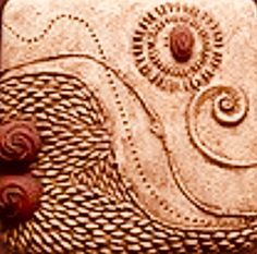 an intricately designed purse is shown in sepia tone, with red roses on the bottom