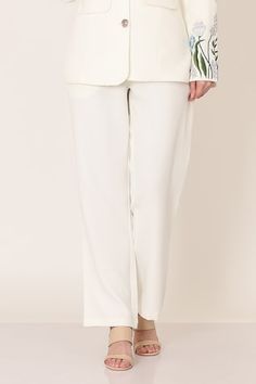 White blazer with floral placement embroidery on the sleeves. Paired with a pant. - Aza Fashions Floral Embroidered Pants For Spring Workwear, Floral Embroidered Straight Pants For Workwear, Floral Embroidery Straight Pants For Workwear, Floral Embroidery Straight Pants For Work, Elegant White Pants With Floral Embroidery, Floral Embroidered Bottoms For Workwear In Spring, Floral Embroidered Bottoms For Spring Workwear, Spring Floral Embroidered Bottoms For Work, Elegant Floral Embroidery Trousers