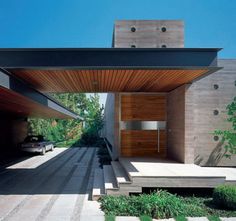 the entrance to a modern house with steps leading up to it