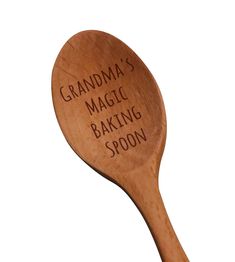 a wooden spoon with the words grandma's magic baking spoon written in black on it