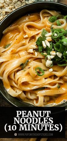 a pan filled with noodles and sauce on top of a wooden table