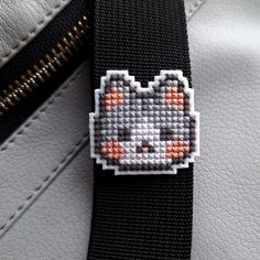 a close up of a bag with a cat on it