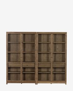 a wooden bookcase with three doors and two shelves on each side, in front of a white background