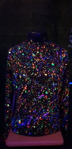 a black shirt with multicolored sprinkles on it