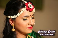 a woman wearing a head piece with flowers on it's forehead and pearls in her hair