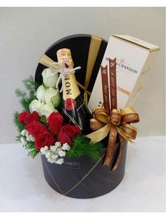 a gift basket with roses, champagne and chocolates for someone's special occasion