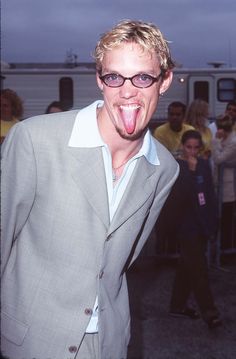 a man sticking his tongue out in front of a crowd