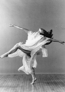 a black and white photo of a woman dancing