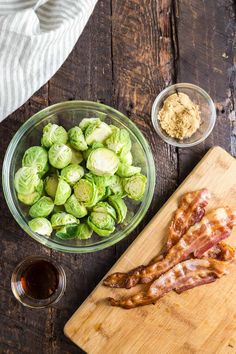 bacon, brussel sprouts and other ingredients on a wooden cutting board