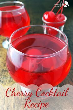 two glasses filled with red liquid on top of a wooden table