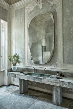 a bathroom with two sinks and a large mirror on the wall above it's counter