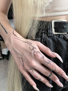 a woman's hand with tattoos on it